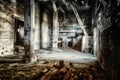 View of an old abandoned warehouse with wooden pillars and cracked walls