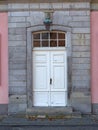 View of the old, antique, white front door to the building with a pink facade Royalty Free Stock Photo