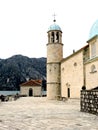 View of the old bell tower and part of the Church of Our Lady of the Rocks