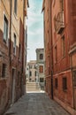View of old buildings in an alley and bridge in Venice. Royalty Free Stock Photo