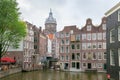AMSTERDAM, NETHERLANDS - JUNE 25, 2017: View of the old buildings and tower of the Basilica of St. Nicholas.