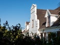 View of an old Cape Dutch house behind some bushes. Royalty Free Stock Photo
