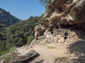 View of old cave shepard shelter on hiking path to Cala Goloritze beach with limestone rocks, trees, green bush. Gulf of Orosei, Royalty Free Stock Photo