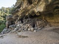 View of old cave shepard shelter on hiking path to Cala Goloritze beach with limestone rocks, trees, green bush. Gulf of Royalty Free Stock Photo