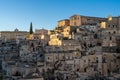 view of the old city center of Matera with the stone houses in the last rays of sunlight