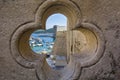 View of old city Dubrovnik through stone carved element of bridge in form of clover, Croatia