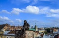 Old city rooftops, sculpture of the chimney sweep sitting on the funnel from top of of restaurant, Lviv, Ukraine Royalty Free Stock Photo