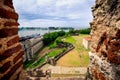 View on old city walls and new industrial port of Santo Domingo, through the window of fortress - fortaleza. Royalty Free Stock Photo