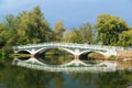 View on old classic bridge in center island with joyful happy people walking toward the beach on sunny day