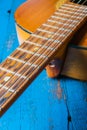 Old classical guitar closeup,on blue background. Royalty Free Stock Photo