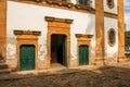 View of old colored church doors and cobblestone street in Paraty. Royalty Free Stock Photo