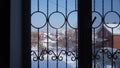 View of the old courtyard from the window of a private house. Snow outside the window. The camera zooms in on the window