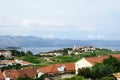 A view an old croatian village and sprawling wine vineyard growing the local grk grapes with the small town of Lumbarda in the bac