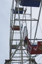 The empty chairs on the old vintage ferris wheel.