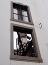 a view of an old factory chimney through the window of an abandoned destroyed industrial building with twisted burned metal