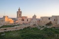 Panoramic view on old, historical St. Joseph`s Chapel inside Citadel of Victoria surrounded by antique ruins, walls with grass