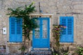 View of old, historical, traditional stone house with blue colored door and windows in famous, touristic Aegean town