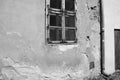 View of an old house with cracks on the wall and window, black and white photo Royalty Free Stock Photo