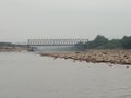 view of the old iron bridge over Chenab river in Akhnoor on a cloudy day