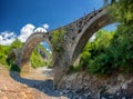 View of the Old Kalogeriko triple arched stone bridge Royalty Free Stock Photo