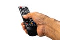 View of old man hand press the button on television remote control to select the television program on white background Royalty Free Stock Photo