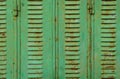 View of an old metal window door with green colour and rust stains. Royalty Free Stock Photo