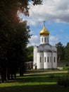 View of old Orthodox white stone church in monastery against background of green trees and cloudy sky. Religion, Christianity. Royalty Free Stock Photo