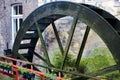 View on old paddle wheel of ancient water mill. Mossy brick wall background. Maastricht, Netherlands Royalty Free Stock Photo