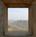 View of the old part of Jaipur, the Maota lake and fortifications on the hill out of the window of ancient fort Jaygarh, Rajasthan