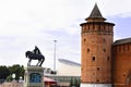 View on old red brick wall and tower of Kolomna Kremlin and shillouette of the Dmitry Donskoy monument on background of modern Royalty Free Stock Photo