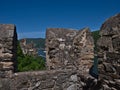 View of old romance castle Rheinstein between two battlements of an ancient stone wall at Rhine river valley near Bingen. Royalty Free Stock Photo