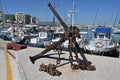 View on old rusty anchor with chain in port of Heraklion near the city center.