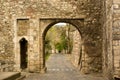 View through old stone arc on pavement Royalty Free Stock Photo