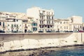 View of old street, facades of ancient buildings in seafront of Ortygia Ortigia Island, Syracuse, Sicily, Italy