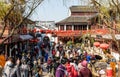 View of Old Street with massive tourists in face masks in Qibao Old Town