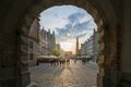 Gdansk, Poland - 05.06.2017: View of an old street with people through arch in historical city. Dlugi Targ street