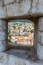View of the old town of Dubrovnik through an opening in the wall of the fortress portrait format in Croatia