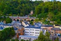 View of old town of Luxembourg. Typical houses and green trees with a train crossing the city Royalty Free Stock Photo