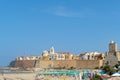 View of the old town of Termoli with beach umbrellas, the colorful houses and Svevo Castle, Termoli, Italy