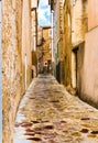 Narrow alley in old mediterranean village Royalty Free Stock Photo