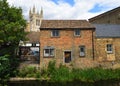 View of old waterside buildings by Hen Brook St Neots with St Marys Church Tower in background.