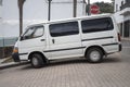 An old white Toyota Hiace van parked outdoors