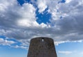 View of old windmill ruins on the coast of Murcia under a blue sky with white clouds