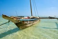 View of an old wooden boat or catamaran, anchored off the Kenyan coast in Africa in the clear sea