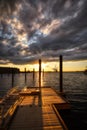 View of the old wooden pier over the sea water at scenic sunset Royalty Free Stock Photo