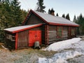 View of an old wooden red house in the middle of a forest in Siljan, Norway during winter Royalty Free Stock Photo