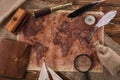 View of old world map near telescope, nib and compass on wooden surface
