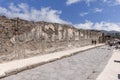 View of one of the city streets with group of tourists in ruins of ancient city, Pompeii, Naples, Italy Royalty Free Stock Photo