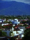 Building, houses and Barisan hills. Royalty Free Stock Photo