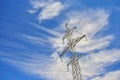 View on one outdoor high voltage electric transmission line support metal construction tower pillon on blue cloudy sky. Metal elec Royalty Free Stock Photo